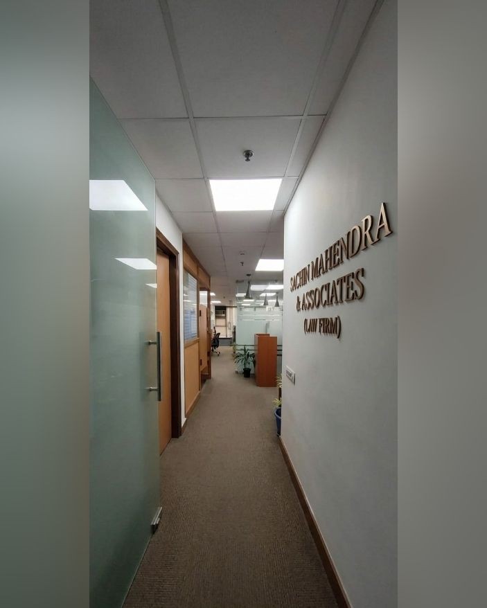 Corridor with the Sachin Mahendra & Associates wall signage at the new office