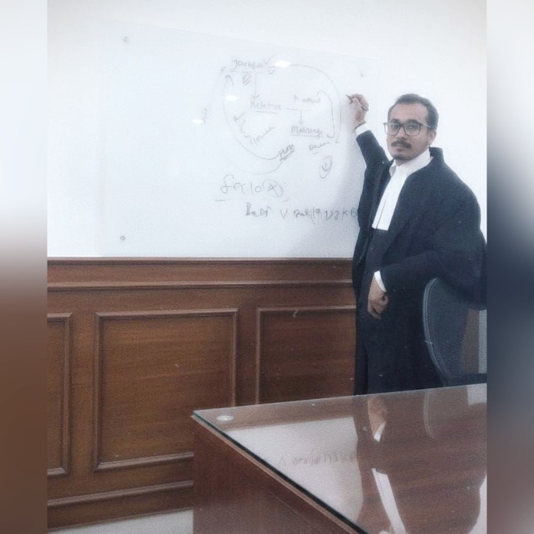 Managing Partner in robes pointing at a whiteboard with case diagrams